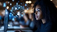 Young African American woman interacting with holographic digital network interface displaying glowing connections and data points in modern office environment.