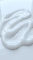 Creamy white whipped texture with swirled peaks and smooth waves, isolated on white background for cosmetic, skincare, and beauty product design use.