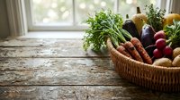 Wicker basket filled with fresh organic vegetables including carrots, eggplant, radishes, and herbs on rustic wooden table by bright window for farmers market, cooking, and healthy eating concepts.