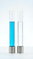 Two laboratory test tubes with metal bases on white background, one filled with bright cyan liquid and one with clear liquid, used for chemical analysis and scientific research.