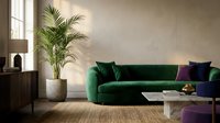 Emerald green velvet sofa with decorative pillows in modern living room featuring potted palm plant, wooden furniture, and natural window light for interior design.