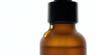 Amber glass bottle with black cap isolated on white background, ready for cosmetic, essential oil, or pharmaceutical product packaging design and branding mockups.
