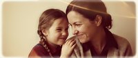 Loving mother and daughter sharing intimate moment together, warm family bonding time with genuine smiles and affection in cozy home setting.