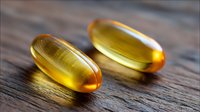 Translucent golden omega-3 fish oil capsules on wooden background with natural lighting and shallow depth of field, macro photography showing supplement details.