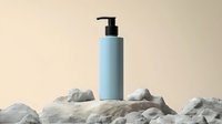 Minimalist blue cosmetic pump bottle on stone composition against beige background. Mockup for skincare, soap, or beauty product packaging design.
