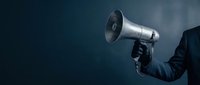 Business professional holding megaphone for corporate communication and marketing announcements on dark background for presentations.
