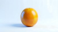 Single fresh orange with glossy skin and water droplets on white background, suitable for food, nutrition, health, and grocery retail marketing materials.