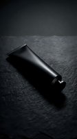 Black disposable lighter on dark textured surface with dramatic lighting and shadows creating moody atmospheric product photography for commercial use.