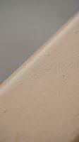 Close-up detail of natural cork material surface with organic texture and porous structure against neutral background for sustainable design projects.
