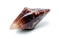 Raw smoky quartz crystal specimen with deep brown coloring and translucent edges on white background, showing natural geometric crystalline formation.