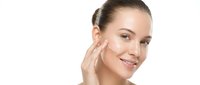 Young Caucasian woman applying facial cream with gentle touch, skincare routine and beauty treatment on white background isolated for cosmetic design.