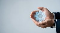 Business professional hands protecting glowing digital gear mechanism representing innovation, technology solutions, and strategic planning concepts.