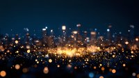 Magical glowing golden particles floating on dark background with bokeh effect and light spots create atmospheric festive mood for holiday designs.