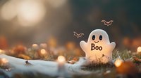 Playful ghost decoration with boo text on autumn background with bokeh lights and fallen leaves, creating spooky Halloween atmosphere outdoors.