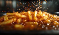 Golden french fries with salt crystals falling in dramatic lighting, extreme close up macro shot showing crispy texture and seasoning against dark background.