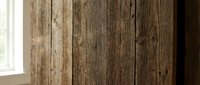 Rustic weathered wooden planks with natural grain texture and vintage patina creating warm interior wall surface for farmhouse and country home decor projects.
