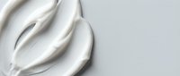 Smooth white cream texture with elegant swirls on clean background for skincare and cosmetic product design applications.