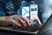 Professional businessman hands typing on laptop with digital email marketing interface, newsletter campaign icons and subscriber analytics floating above keyboard.