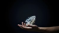 Hand holding glowing neon rocket icon against dark background, representing startup launch, innovation, business growth, and entrepreneurial success for web and marketing use.