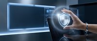 Businesswoman holding glowing shield symbol representing cybersecurity protection, data safety, and digital defense in modern office environment for security concepts.