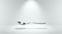 Isolated silver spoon with curved handle on white background, ready for design use on product packaging, kitchenware marketing, restaurant menus, and tableware promotional materials.