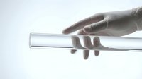 Close-up of hand holding transparent glass test tube in laboratory setting. Scientific research and medical testing concept for educational materials.