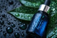 Blue glass bottle with water drops on dark background with green leaves and morning dew, luxury cosmetic product photography for spa and wellness advertising.