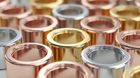 Metallic cylinders in gold, silver, copper, and rose gold colors arranged in rows, creating a luxurious industrial pattern for jewelry or manufacturing.