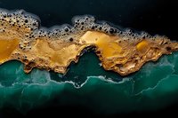 Aerial view of natural abstract pattern formed by mineral deposits and water creating dramatic contrast between golden yellow and deep turquoise colors.