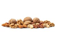 Mixed nuts and almonds collection isolated on white background for healthy snacking and cooking ingredients.