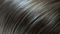 Macro shot of dark gray hair strands creating abstract curved lines and patterns against black background. Natural texture and shine detail for beauty and fashion design.