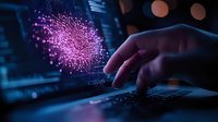 Glowing pink virus particle visualization on computer screen while person types on laptop keyboard in dark room, highlighting digital healthcare research.