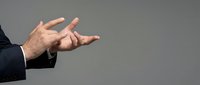 Business professional hands gesturing during presentation or speech against neutral background for corporate communication and leadership concepts.