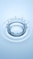 Water splash crown formation with droplets suspended in motion against light blue background, suitable for cosmetics, skincare, and beverage product packaging.