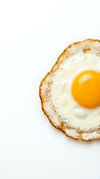 Crispy fried egg with golden yolk on white background, isolated breakfast food for cooking and culinary design projects.
