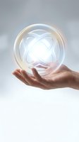 Hand holding glowing transparent sphere with luminous orbital rings inside, symbolizing innovation, technology, and future concepts for business and science applications.