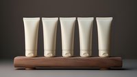 Five white cosmetic tubes arranged in row on wooden stand against dark background, mockup for beauty product packaging and branding presentations.