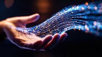 Glowing magical sparkles and light streams floating above open palm against dark background, creating ethereal atmosphere with bokeh effect and blue illumination.