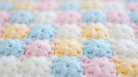 Soft pastel colored yarn pom poms arranged in rows creating textured craft background for DIY projects and handmade decorations.