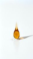 Amber liquid droplet with pointed top isolated on white background, suitable for cosmetics, skincare, essential oils, serums, and wellness product design.