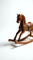 Vintage wooden rocking horse with colorful painted saddle and ornate details, isolated on white background, classic children's toy collectible.