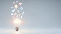 Glowing light bulb with floating innovation icons and symbols representing creative ideas, technology, and business solutions on clean background.