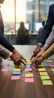 Business team collaborating with colorful sticky notes on wooden table in modern office environment for creative brainstorming and project planning sessions.