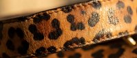 Leopard print fabric strip with natural spotted pattern texture, suitable for fashion design, textile backgrounds, and apparel mockups.