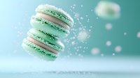 Mint green macarons floating in air with sparkles and bokeh effects against turquoise background, creating magical pastry composition for food photography.