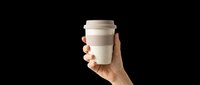 Reusable coffee cup held in hand, isolated on transparent background. Ready for t-shirt design, clipart, stickers, print-on-demand products and sublimation projects.