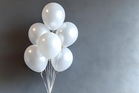 White party balloons bunch floating against gray wall background, minimalist celebration design with copy space for text or logo placement.