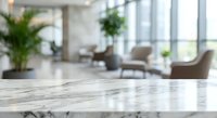 Empty marble table surface in modern office lobby with blurred background of contemporary furniture and large windows for product display mockups.