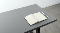 Open notebook with blank pages on gray table with pen, suitable for journaling, note-taking, planning, education, and office workspace design projects.