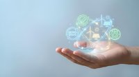 Hands holding glowing digital icons representing renewable energy, zero waste, and sustainable technology solutions for environmental conservation and green business initiatives.